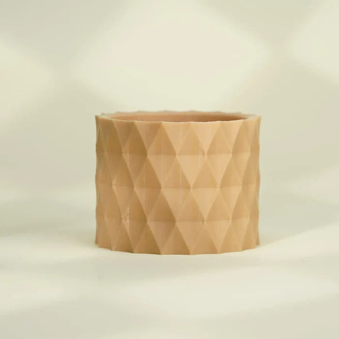 Beige cylindrical planter with a geometric pattern, 3D printed using Flashforge PLA 1.75mm Filament - Basic Colour, set against a softly blurred background.