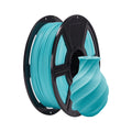 A spool of Flashforge PLA Matte Colour 1.75mm filament in turquoise sits beside a matching spiral-patterned 3D printed vase, ideal for precise prints.