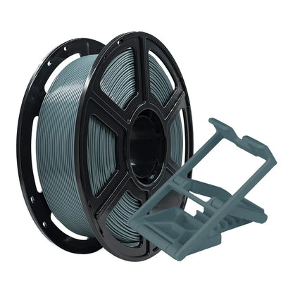 A spool of Flashforge PLA Pro 1.75mm 3D Printing Filament in gray is displayed next to a small, geometric 3D-printed plastic object.