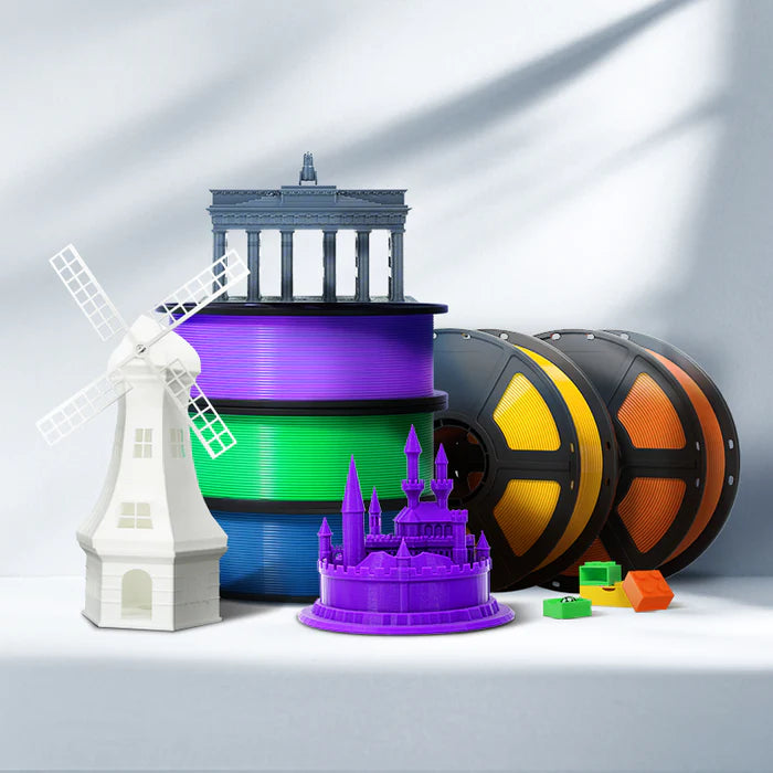 Flashforge PLA Pro 1.75mm Basic Colour 3D Printing Filament spools are stacked beside high-accuracy 3D printed models of a windmill, building, and castle, plus small colored blocks.
