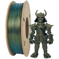 A spool of Toyar's shimmering green PLA Magic Color 1.75mm Filament, renowned for its sparkling effects, sits beside a small Samurai figure, both showcasing stunning metallic effects.