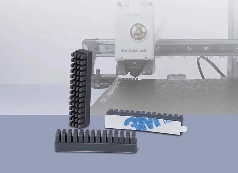 The Silicone Nozzle Wiper Brush Set (3-Pack) for the Bambu Lab A1 Mini 3D Printer includes three black plastic components, along with a white adhesive strip prominently featuring the 3M logo—perfect for maintaining your 3D printer.