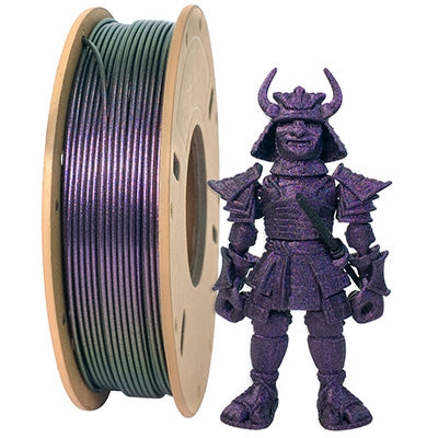 A Toyar PLA Magic Color 1.75mm Filament (Sparkling) spool, noted for its metallic effects, sits beside a detailed 3D-printed samurai figure in striking purple.