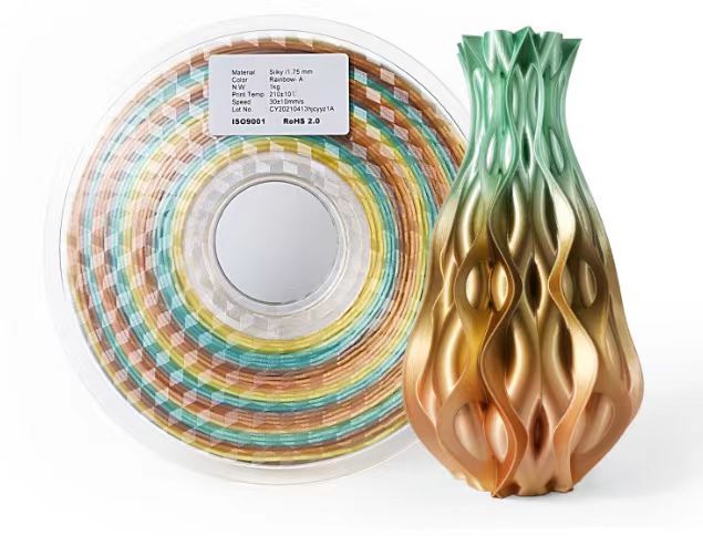 A spool of Hello3D TPU Flexible Standard Colour 1.75mm 3D Printing Filament is shown beside a vibrantly colored, intricately patterned 3D-printed vase, both from Hello3D.