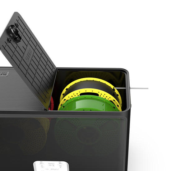 A black SUNLU S4 FilaDryer container from the brand SUNLU holds several colorful spools with a partially open lid, allowing a filament strand to extend out and ensuring optimal drying for vibrant multi-color printing.