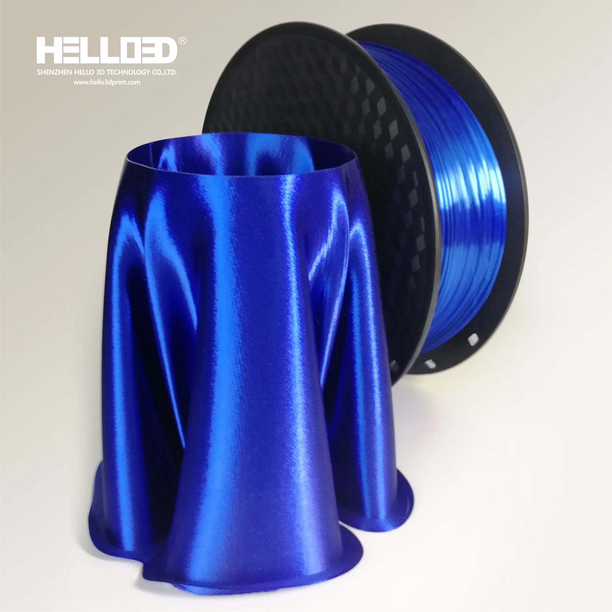 A spool of Hello3D PLA SILK Colour 1.75mm filament stands beside a glossy, silk-like 3D print—ideal for luxury projects using Hello3D’s premium 3D printing material.