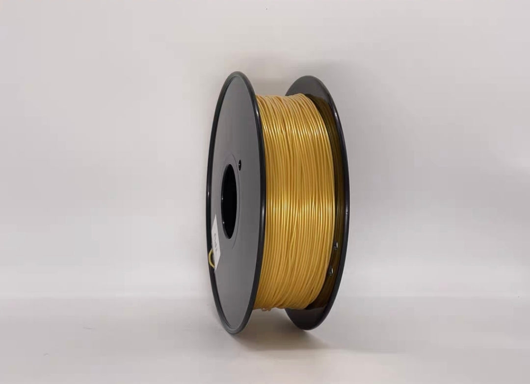 A spool of Toyar TPU Standard Colour 1.75mm 3D Printing Filament, featuring a shiny golden finish, is shown against a plain white background—ideal for creating flexible 3D prints.