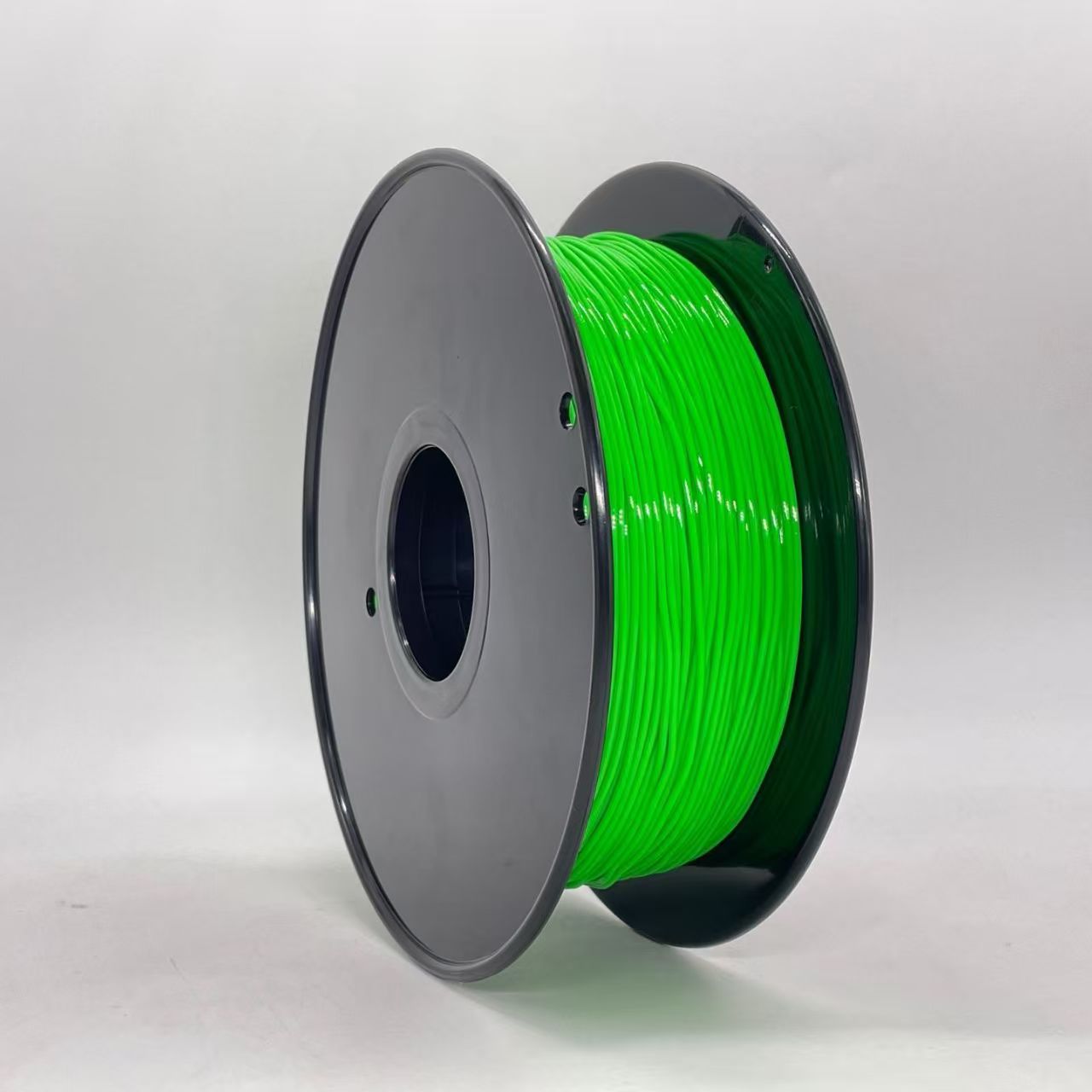A spool of Toyar TPU Standard Colour 1.75mm 3D Printing Filament in bright green with black end caps stands upright against a plain white background—perfect for flexible filament projects.