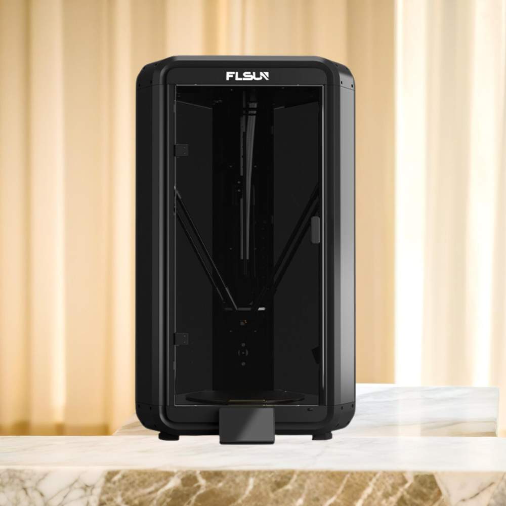 The 3D printer Flsun T1 fast 1000mm/s with integrated AI Features, a high-speed product from FLSUN, elegantly sits atop a sleek marble table.