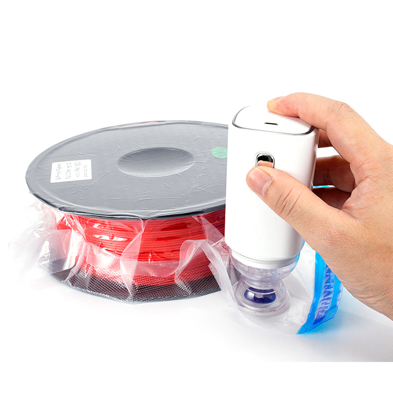 A hand seals a bag with the 3D Printing Perth - Cirrus Link Electric Filament Vacuum Storage Kit, demonstrating how to protect moisture-sensitive filament.