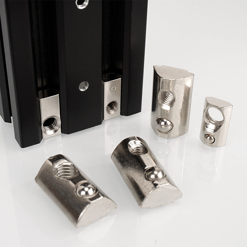 The Aluminium Profile Elastic Ball Nut Type 20, by 3D Printing Perth - Cirrus Link, along with metal brackets and connectors, is displayed beside a black vertical structure on a white surface.