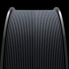 Close-up of a textured, black ribbed surface curved around a cylindrical shape, created from MakerHero CF Blend™ PETG Carbon Fibre Reinforced Filament, set against a dark background.
