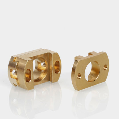 Two precision-machined brass Oldham Couplers for T8 Z Axis Screw Upgrade, designed by 3D Printing Perth - Cirrus Link for BLV Ender 3 Creality machines, are shown with multiple holes and cutouts on a white reflective surface.