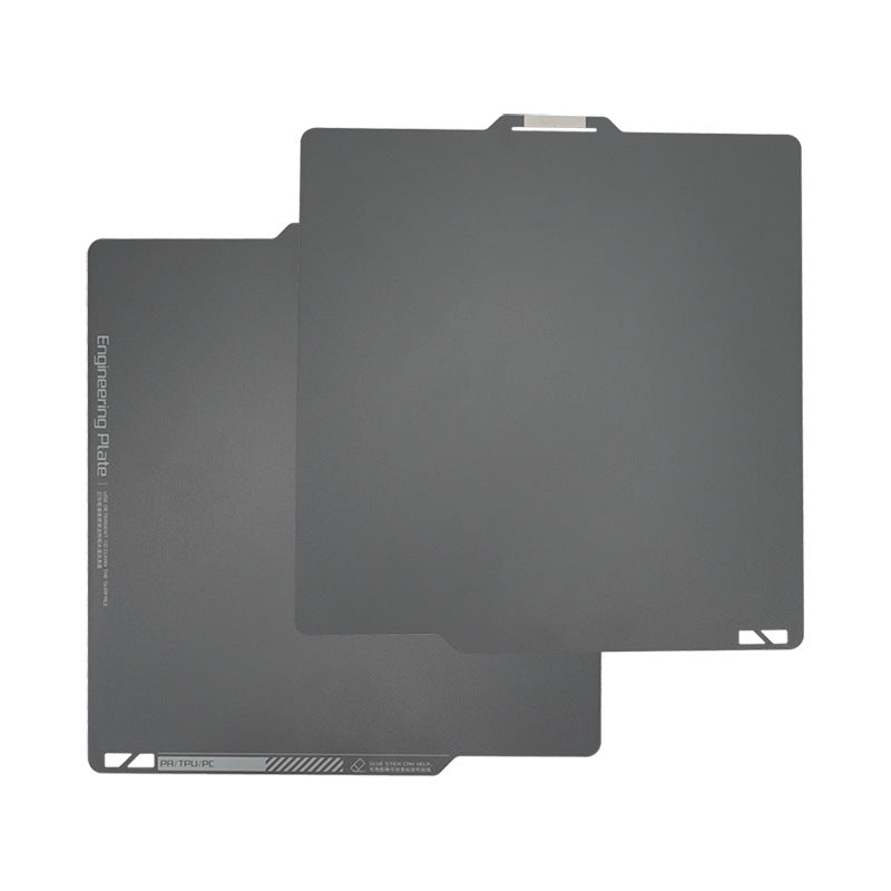 Two overlapping dark gray engineering plates with rounded corners are made from magnetic steel film, featuring a smooth surface and a top tab, designed specifically for the Bambu Lab X1 Magnetic Steel 268*258mm Print Surface by 3D Printing Perth - Cirrus Link.