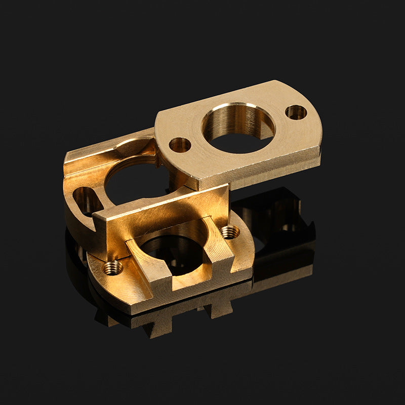 Two precision-machined brass components from 3D Printing Perth - Cirrus Link, designed for the Oldham Coupler T8 Z Axis Screw Upgrade for BLV Ender 3 Creality Machines, feature circular openings and threaded holes on a reflective black surface.