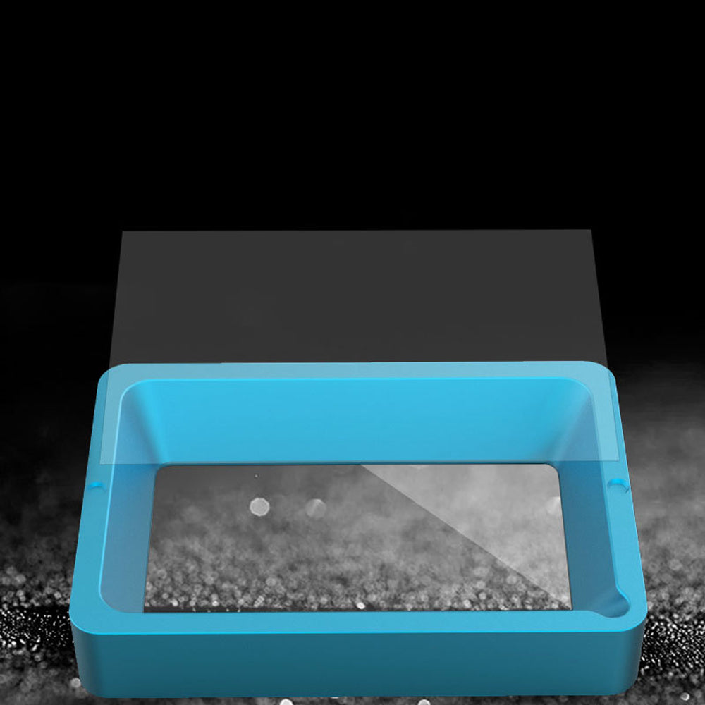 Sitting on a dark textured surface, the FEP Film 0.15mm 260x200mm for Anycubic M3 PLUS Resin Printer from 3D Printing Perth - Cirrus Link is displayed next to a blue rectangular case, highlighting its exceptional UV light transmission for optimal clarity.