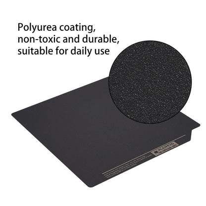 The black rectangular Polyurea Hot Bed Platform from 3D Printing Perth - Cirrus Link measures 310*315mm and is double-side coated, featuring a textured surface that is non-toxic and durable—perfect for enhancing the Creality K1 Max 3D printing experience with materials like PLA, PETG, and ABS.