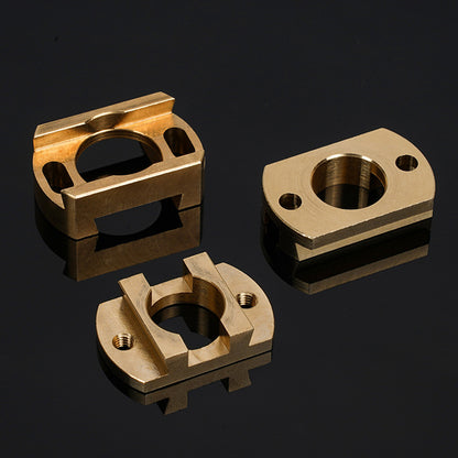 Three precision-machined brass Oldham Coupler T8 Z Axis Screw Upgrades from 3D Printing Perth - Cirrus Link, designed for BLV Ender 3 Creality machines, with circular and threaded holes, displayed on a glossy black surface.